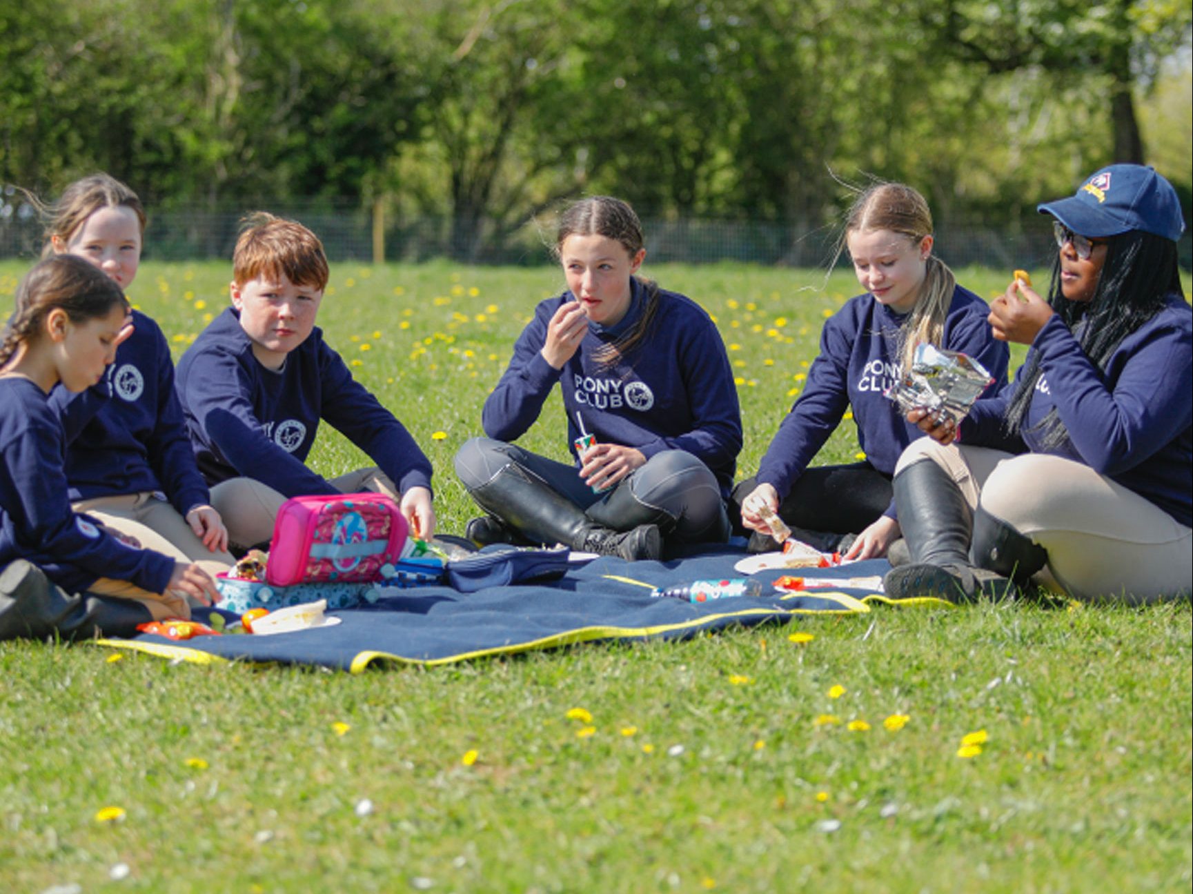 A group of 6 children enjoying a picnic